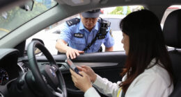 Body cam footage from cop who pulled over woman for holding a phone in her other hand